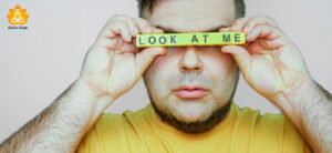 man holding look at me in front of his eyes