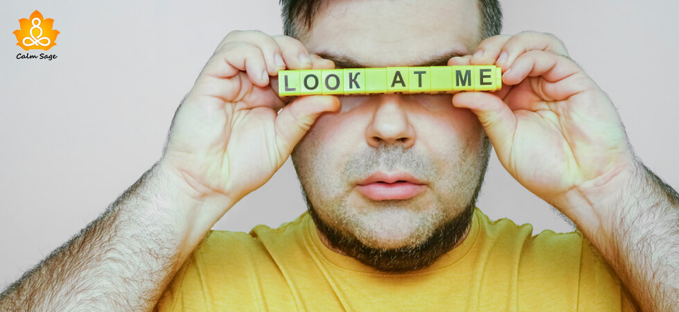 man holding look at me in front of his eyes